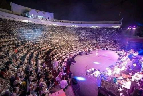 a large crowd of people in an auditorium at a concert at شقة وسط أكادير in Agadir
