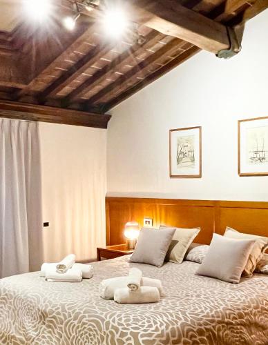 a bedroom with a large bed with towels on it at Residence Internazionale in Pietrasanta