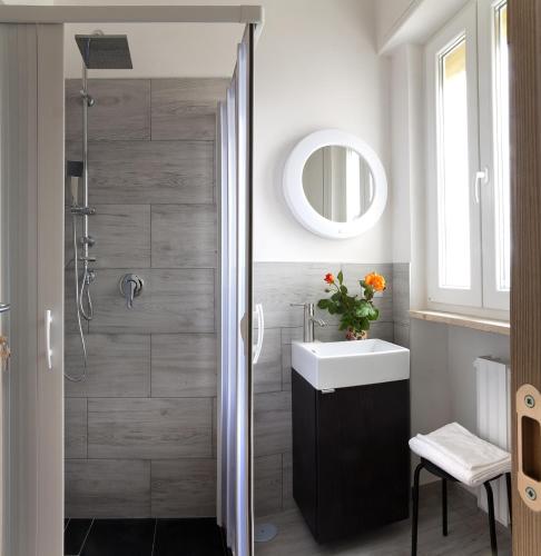 a bathroom with a shower with a sink and a mirror at vento di mare in Bari
