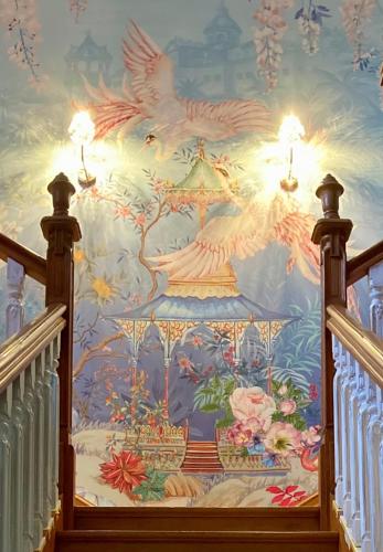 a painting of birds on the ceiling of a staircase at La Villa des Roses Gîte Chambres d'hôtes Piscine chauffée in Luçon