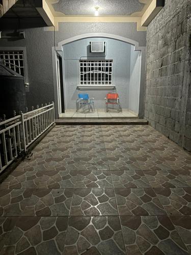 a room with two chairs sitting on a floor at Hospedaje en Juticalpa in Juticalpa