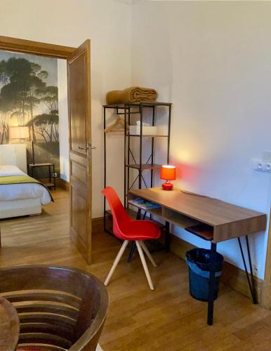 a room with a desk and a bed and a desk and a chair at La Villa des Roses Gîte Chambres d'hôtes Piscine chauffée in Luçon