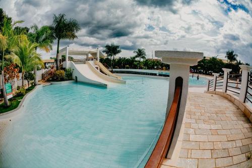 a swimming pool with a slide in a resort at Lacqua Diroma 1 2 3 4 5 in Caldas Novas