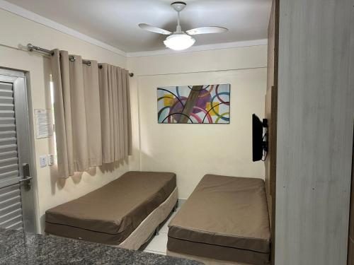a room with two beds and a ceiling fan at Lacqua Diroma 1 2 3 4 5 in Caldas Novas