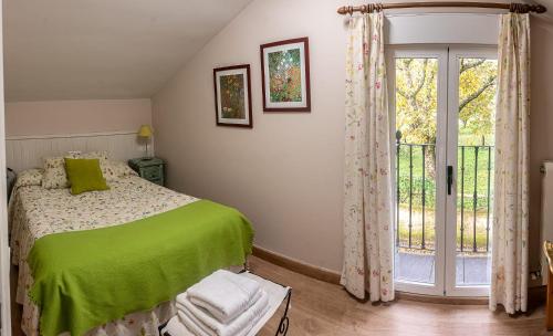 a bedroom with a bed and a sliding glass door at Casitas Del Huerto in La Alberca