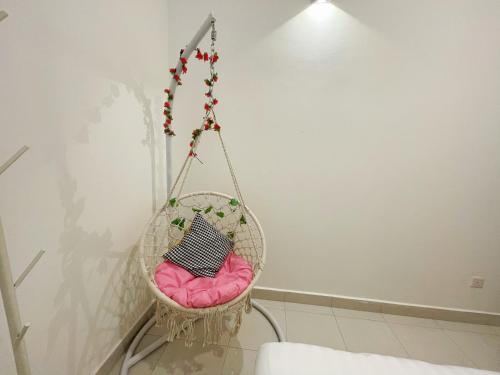 a hanging chair with a pink cushion in a room at Bandar putra Ktv Snooker BBQ/IOI Mall/JPO/Aeon/Senai Airport/Kulai in Kulai