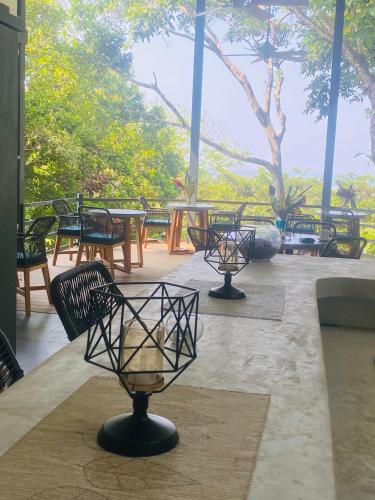 a group of benches and tables with trees in the background at Villas en el Bosque in Ojochal
