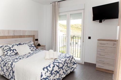 Ένα ή περισσότερα κρεβάτια σε δωμάτιο στο Apartamentos El Chorrilllo
