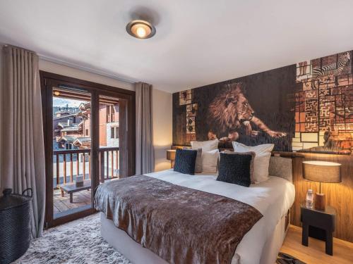 a bedroom with a large bed with a painting on the wall at Chalet Courchevel 1650, 6 pièces, 12 personnes - FR-1-563-141 in Courchevel