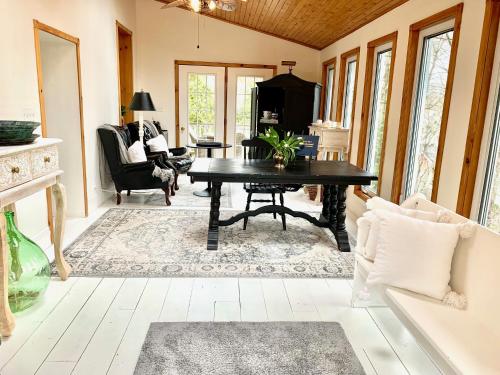 a living room with a black table and chairs at Plantation House Bed & Breakfast in Port Hope