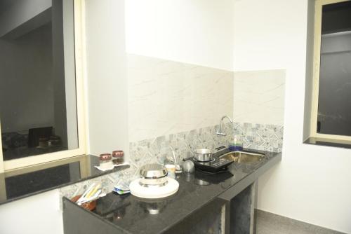 a bathroom with a sink and a counter top at Sai Homestay Panaji Studio in Panaji