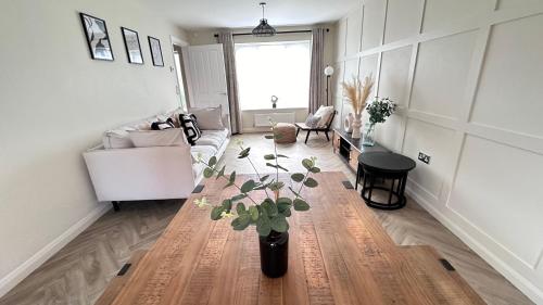 a living room with a couch and a table at Durham Holiday Home in Durham