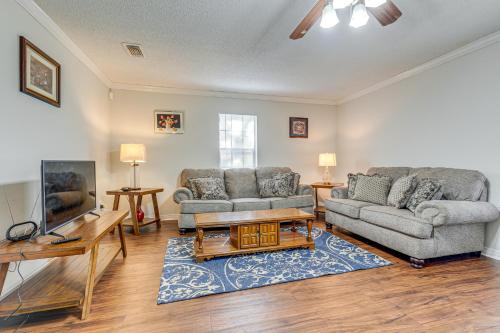 a living room with two couches and a tv at Charming Satsuma Home about 14 Mi to Mobile! in Saraland