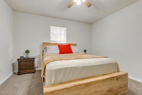 a bedroom with a bed with a wooden frame and a window at Charming Satsuma Home about 14 Mi to Mobile! in Saraland