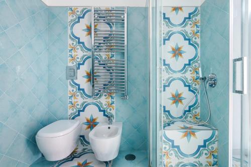 a bathroom with a toilet and a sink at Villa Prota in Vico Equense