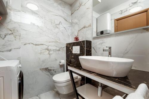 a bathroom with a sink and a toilet at Apartman No 15 in Split