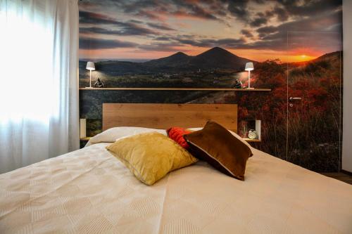 a bedroom with a bed with a view of a mountain at La Giuggiola in Arqua Petrarca
