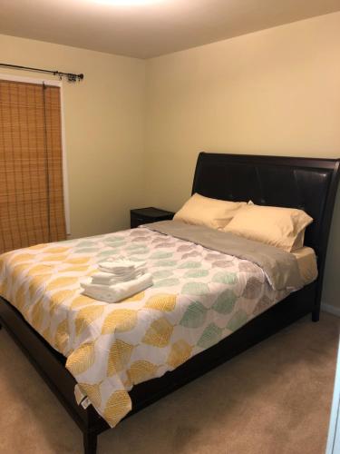a bedroom with a bed with a quilt on it at Entire townhome available near nice park library and shopping in Winston-Salem
