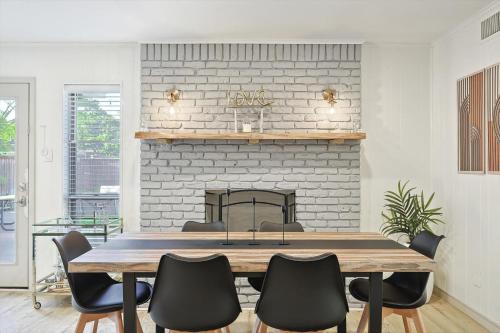 a dining room with a table and a fireplace at Spectacular 6BR 2,5BA Holiday Home with Pool in Dallas