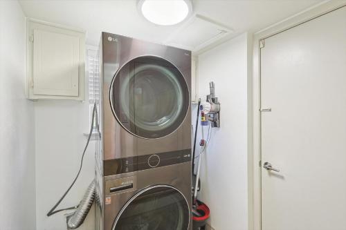 a washer and dryer in a corner of a room at Spectacular 6BR 2,5BA Holiday Home with Pool in Dallas