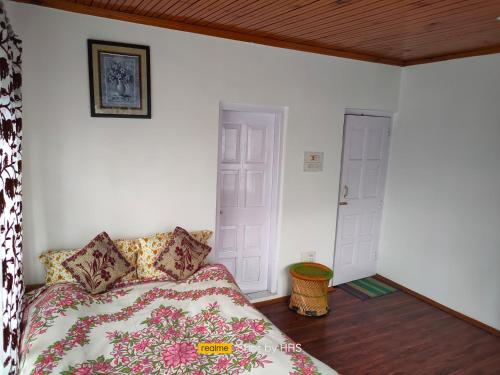 a bedroom with a bed in a room with a door at HHs in Pahalgām
