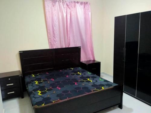 a bedroom with a black bed with stars on it at 1 BHK Fully Furnished Flat in Sharjah