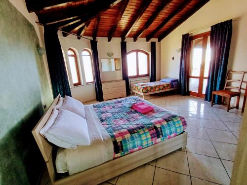 a bedroom with a bed in a room with windows at Monti e Mare in Lanusei