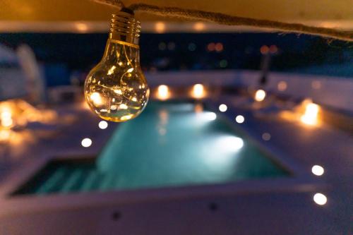 a light bulb hanging from a string with lights at Holiday Home Swiss in Cavtat