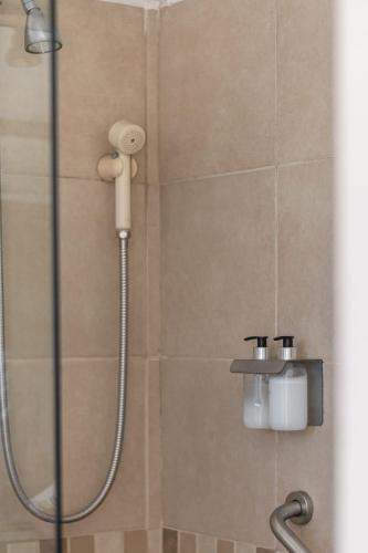 a shower with a shower head in a bathroom at Apart Hotel Rio Grande in Rosario