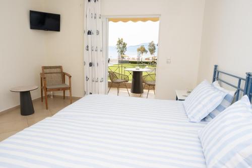 a bedroom with a large bed and a balcony at Apolonio Pefki Evia in Pefki