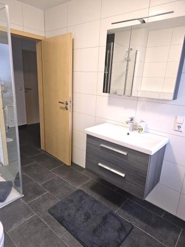 a bathroom with a sink and a mirror at MY HOME N 35/1 in Villingen-Schwenningen