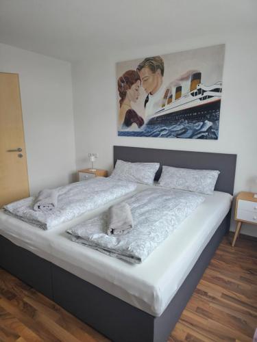 a bed in a room with a picture on the wall at MY HOME N 35/1 in Villingen-Schwenningen
