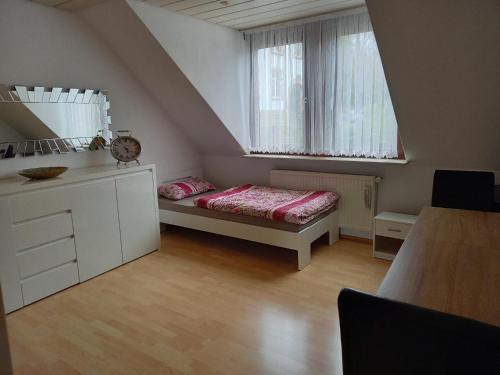 a small room with a bed and a window at Ferienwohnung Enz, 3 OG. in Pforzheim