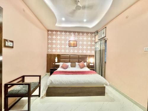 a bedroom with a large bed and a window at HOTEL NEEL GAGAN ! VARANASI fully-Air-Conditioned hotel at prime location, near Kashi Vishwanath Temple, and Ganga ghat in Varanasi