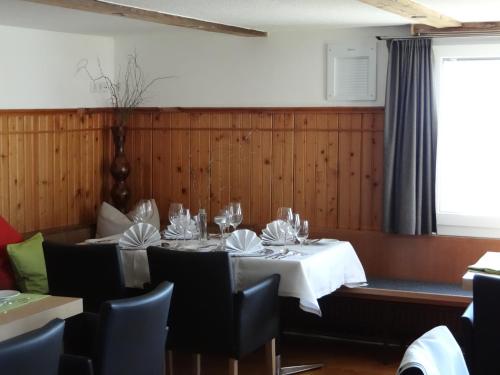 a dining room with a table with a white table cloth at Waldrast Bed & Breakfast in Batschuns