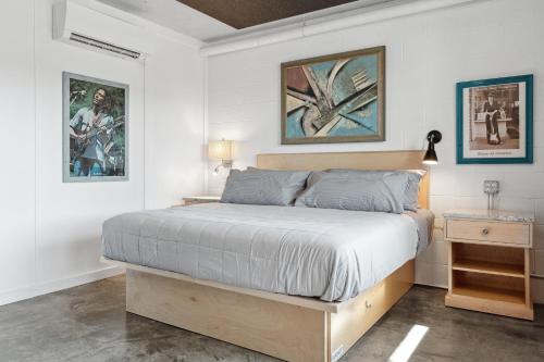 a bedroom with a bed and two pictures on the wall at Boutique Vera Hotel in the Heart of Folly Beach in Folly Beach
