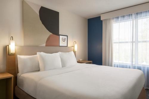 A bed or beds in a room at Spark by Hilton Orlando Universal Blvd