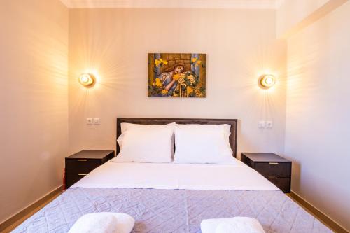 a bedroom with a bed and two night stands at Villa Danai in Karpathos Town