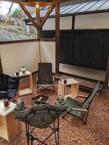 a screened in porch with two chairs and a table at Ohruri, a camp-style inn where you can enjoy a bon - Vacation STAY 48658v in Iwai