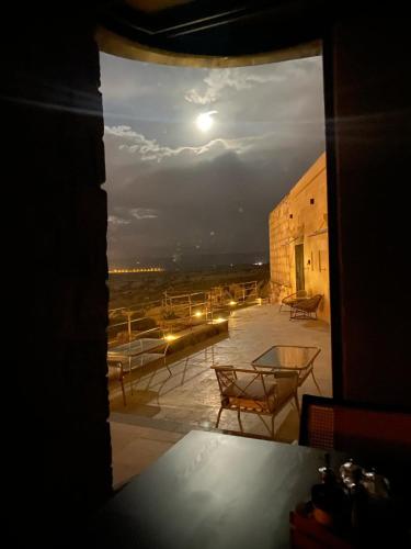 a view from a window of a patio at night at Very Peri Cappadocia - The Lifestyle Luxury Design Hotel in Uchisar
