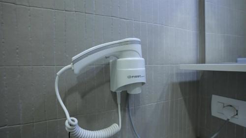 a shower head on a wall in a bathroom at Gent's Inn in Durrës