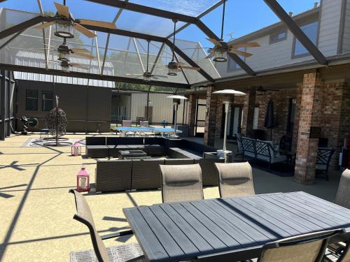 a patio with a table and chairs and a pool at The Retreat at Hempstead in Hempstead