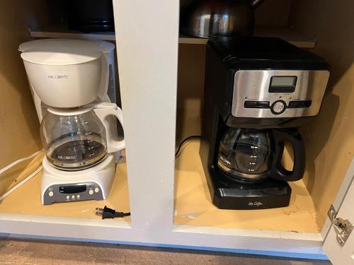 a coffeemaker and a coffee maker on a shelf at The Retreat at Hempstead in Hempstead