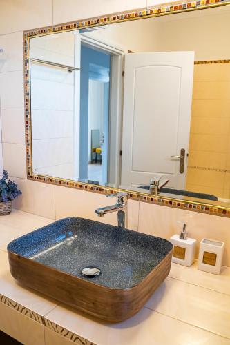 a bathroom with a wooden sink and a mirror at Villa Danai in Karpathos Town