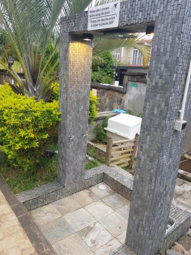 a mirror in the middle of a garden at Villas Rocher - Standard Suite 2B in Grand Baie