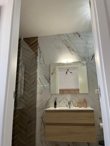 a bathroom with a sink and a shower and a mirror at Garana in Playa Blanca