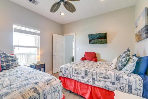 a bedroom with two beds and a ceiling fan at Modern Crystal Beach Escape, Walk to Beach! in Crystal Beach