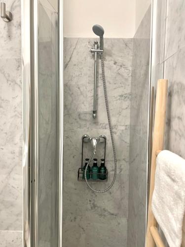 a shower with a glass door in a bathroom at BELLE ILE PARK in Griante Cadenabbia