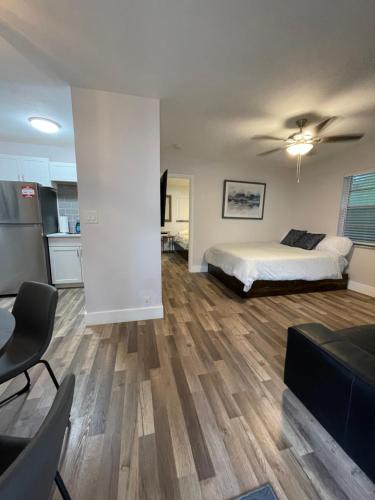 a living room with a bed and a kitchen at City First Story Apartments & Cottage in Fort Lauderdale