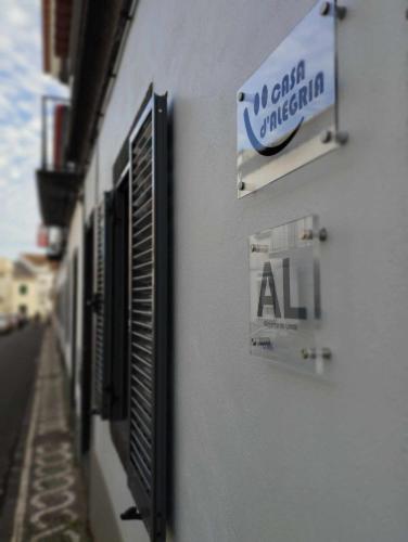 a sign on the side of a building at Casa D'Alegria in Ponta Delgada